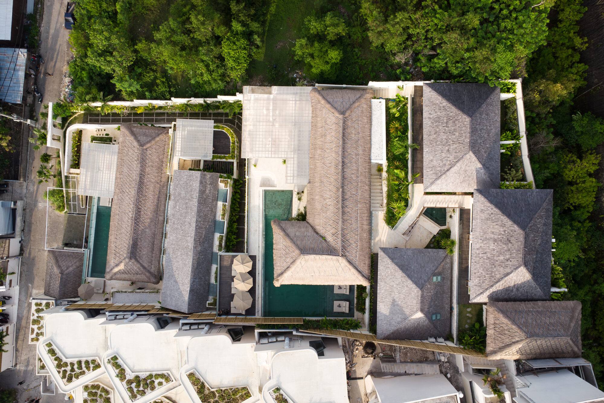 The Maison Ulu estate at golden hour — both villas in one frame.