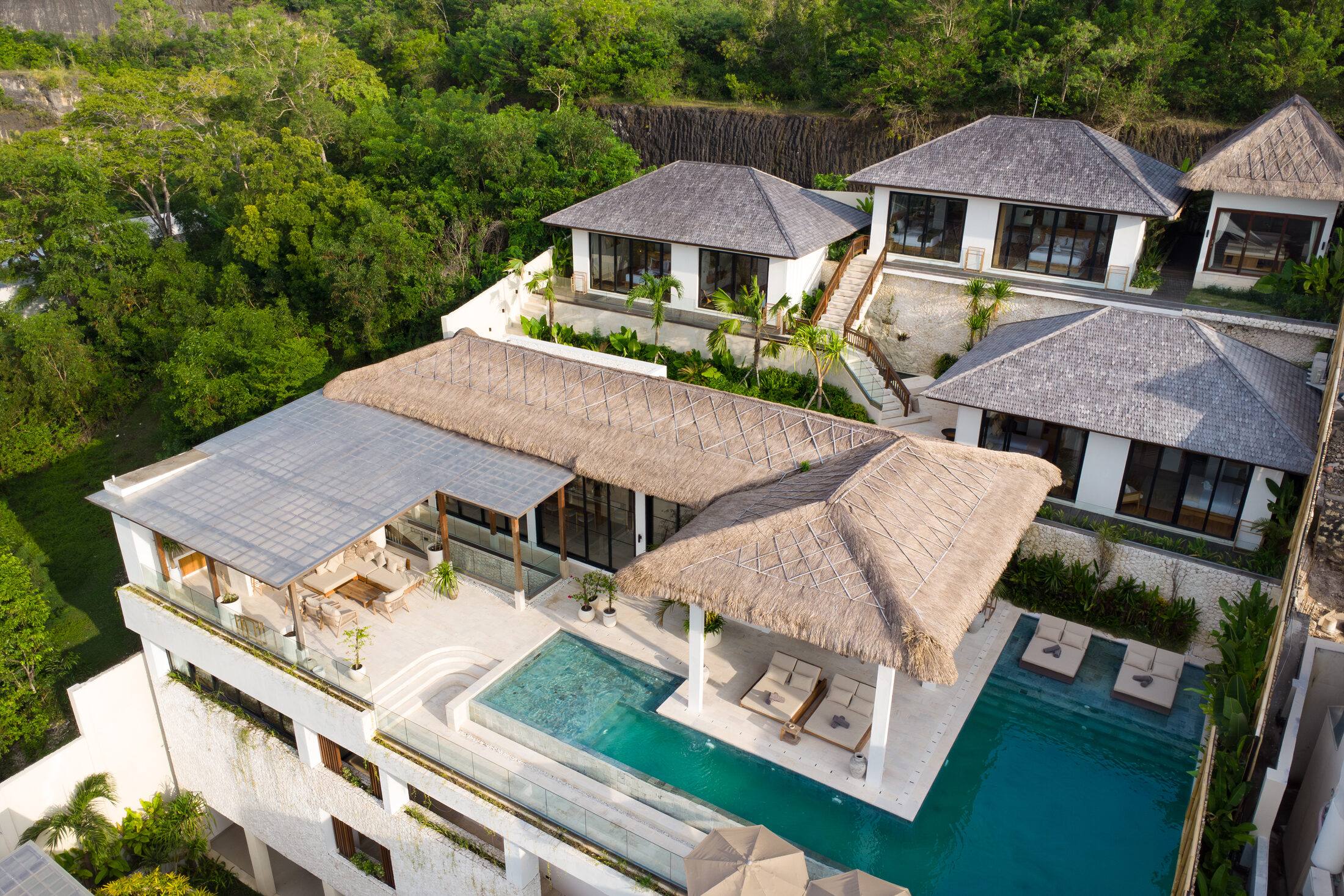 Maison Ulu Satu at golden hour, drone view of the terraced hillside villa.