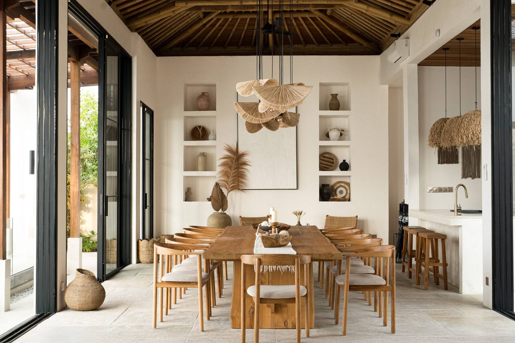 A living space at Maison Ulu Satu, high ceilings, hillside light.