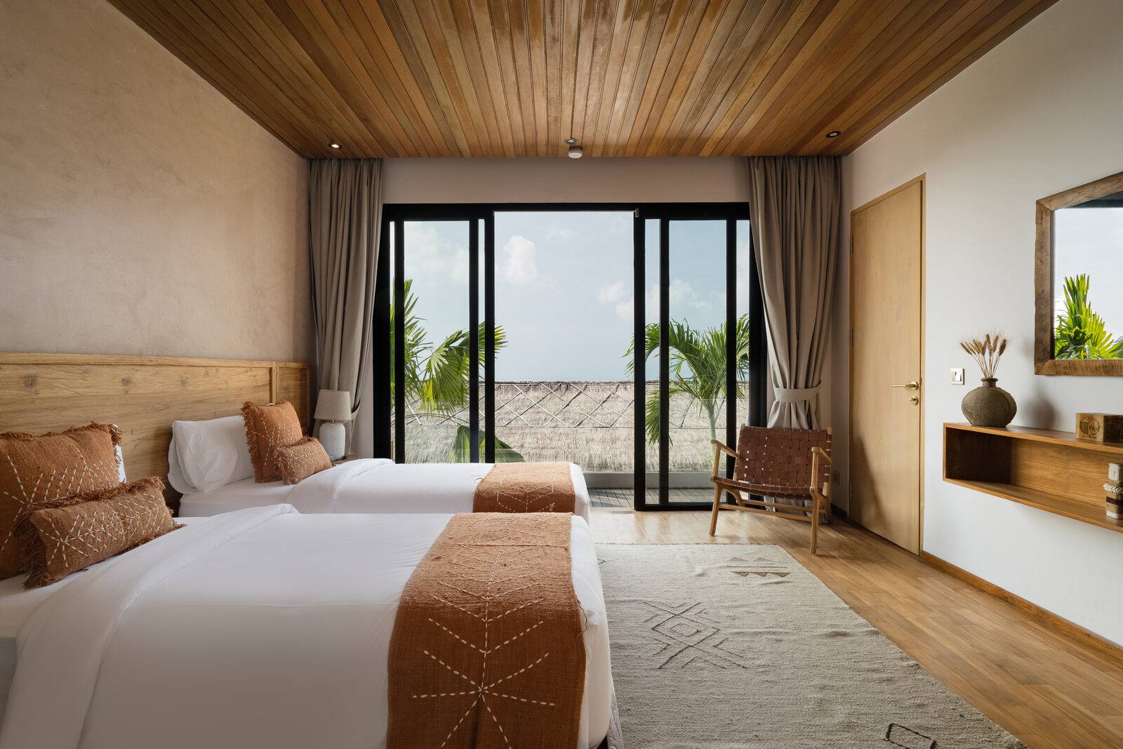 A living space at Maison Ulu Satu, soft morning light through linen curtains.